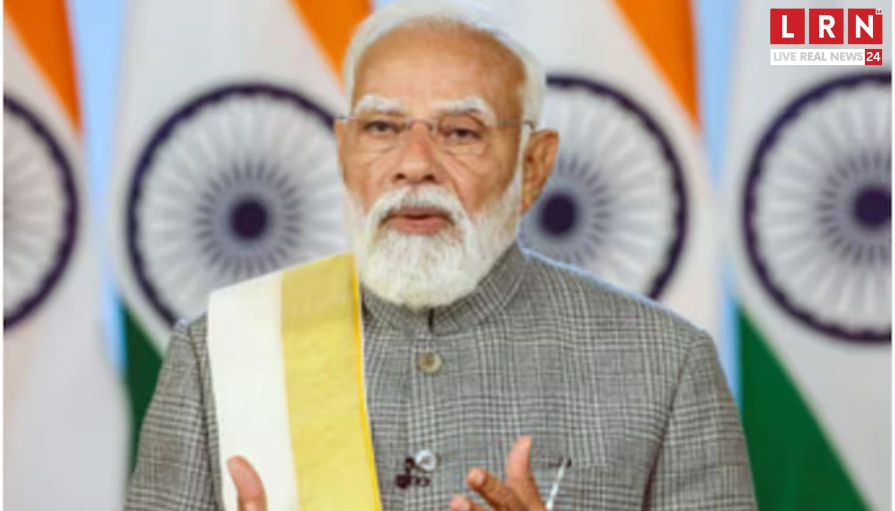 Man speaking with Indian flags behind